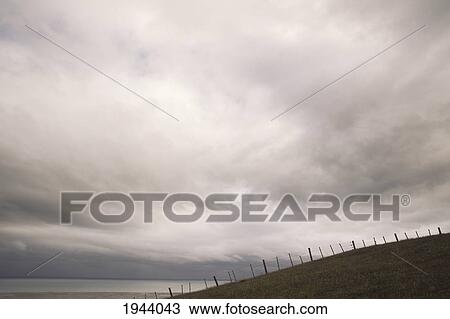 Stock Image - A Fence On A Hill Along The Coast; Farewell Spit South Island New Zealand. Fotosearch