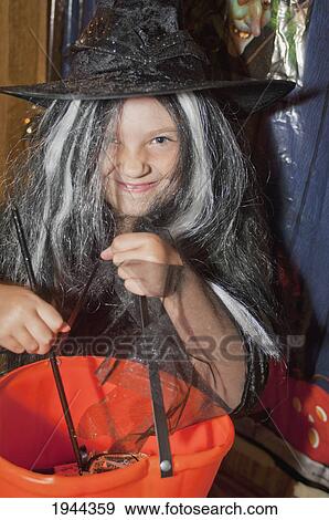 a girl in a witch costume wit a pumpkin candy basket; moraga california united states of america View Large Photo Image Stock Photo - a girl in a witch costume wit a pumpkin candy basket; moraga california united states of america. Fotosearch