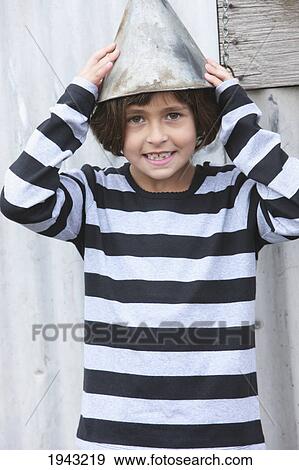 Stock Photo - A Girl Wearing A Striped Shirt With A Funnel Like The Tin Man On Her Head; Troutdale Oregon United States Of America. Fotosearch