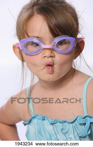A Little Girl Wearing Swimming Goggles And Making A Fish Face With Her Lips; Troutdale Oregon United States Of America View Large Photo Image Picture - A Little Girl Wearing Swimming Goggles And Making A Fish Face With Her Lips; Troutdale Oregon United States Of America. Fotosearch