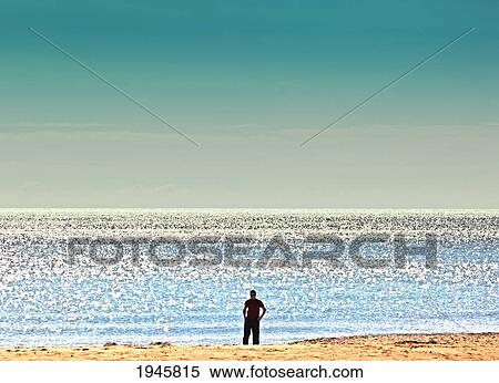 Stock Photography - a lone man on the seashore; torremolinos malaga andalusia spain. Fotosearch