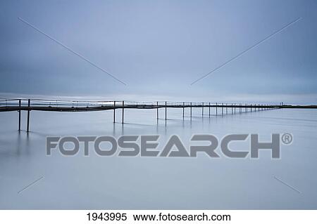 Stock Photography - A Long Walking Bridge Over The Water; Iceland. Fotosearch