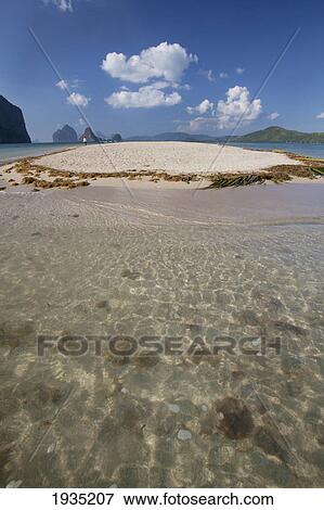 Stock Photo - A Male Tourist Walks Along The White Sand On A Small Island Near El Nido; Bacuit Archipelago, Palawan, Philippines. Fotosearch