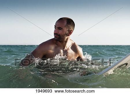 a man with his surfboard in the water; tarifa cadiz andalusia spain View Large Photo Image Stock Image - a man with his surfboard in the water; tarifa cadiz andalusia spain. Fotosearch