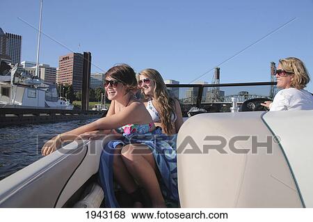 Stock Photo - A Mother And Two Teenage Girls In Bathing Suits Riding In A Ski Boat Down The Willamette River; Portland Oregon United States Of America. Fotosearch