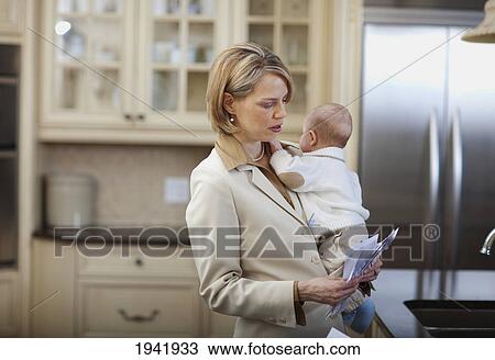 A Mother Holding A Baby And Stressed About Bills And Finances; Jordan Ontario Canada View Large Photo Image Stock Image - A Mother Holding A Baby And Stressed About Bills And Finances; Jordan Ontario Canada. Fotosearch