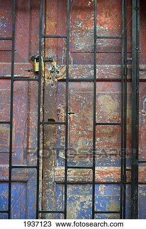 Stock Image - A Padlock On A Weathered Door; Cusco Peru. Fotosearch