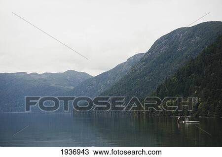 A Person Dives Into Cameron Lake Off A Floating Dock; British Columbia Canada View Large Photo Image Stock Image - A Person Dives Into Cameron Lake Off A Floating Dock; British Columbia Canada. Fotosearch