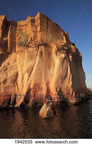 Stock Image - A Person Lays On A Rock In The Water On The Shoreline Of Espiritu Santo Island Near La Paz; Baja California Mexico. Fotosearch