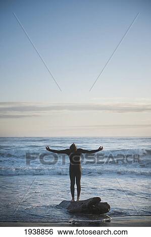 A Person With Arms Outstretched Looking At The Sky While Standing On A Piece Of Driftwood At The Ocean's Edge; La Push Washington United States Of America View Large Photo Image Stock Photograph - A Person With Arms Outstretched Looking At The Sky While Standing On A Piece Of Driftwood At The Ocean's Edge; La Push Washington United States Of America. Fotosearch