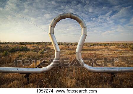 a pipe in a unique shape in a grass field; mckittrick california united states of america View Large Photo Image Picture - a pipe in a unique shape in a grass field; mckittrick california united states of america. Fotosearch