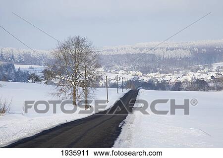 A Road Through Snow Covered Fields In Winter; Westerwald Region, Rheinland-Pfalz, Germany View Large Photo Image Stock Image - A Road Through Snow Covered Fields In Winter; Westerwald Region, Rheinland-Pfalz, Germany. Fotosearch