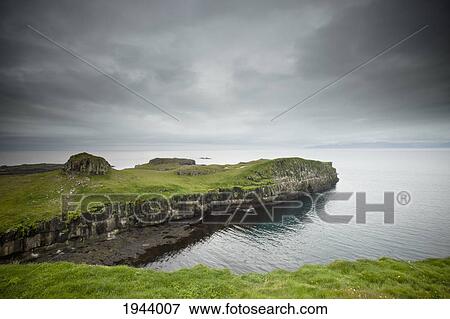 A Rock Ledge Along The Shoreline Under Dark Clouds; Papey Island Iceland View Large Photo Image Stock Photo - A Rock Ledge Along The Shoreline Under Dark Clouds; Papey Island Iceland. Fotosearch
