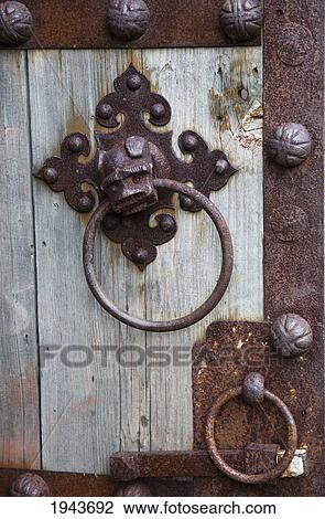 Stock Image - A Rusty Door Knocker On A Rusted Door; Northumberland England. Fotosearch