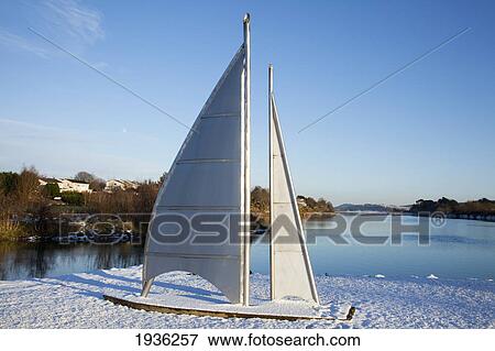 A Sailboat Covered In Snow On The Shore Of A Lake In Winter; Carrigaline County Cork Ireland View Large Photo Image Stock Photo - A Sailboat Covered In Snow On The Shore Of A Lake In Winter; Carrigaline County Cork Ireland. Fotosearch