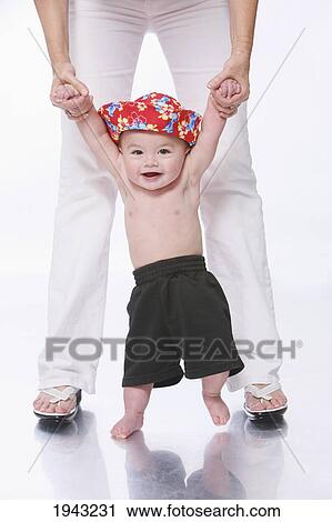 A Shirtless Baby Boy Standing Between Mother's Legs; Troutdale Oregon United States Of America View Large Photo Image Stock Image - A Shirtless Baby Boy Standing Between Mother's Legs; Troutdale Oregon United States Of America. Fotosearch