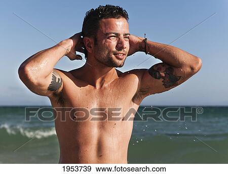 a shirtless man with the ocean in the background; tarifa cadiz andalusia spain View Large Photo Image Stock Photo - a shirtless man with the ocean in the background; tarifa cadiz andalusia spain. Fotosearch