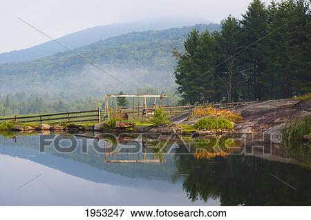 Stock Photo - a small pond in the early morning fog; iron hill quebec canada. Fotosearch