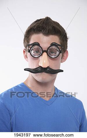 Stock Photo - A Teenage Boy Wearing A Groucho Marx Mask; Troutdale Oregon United States Of America. Fotosearch