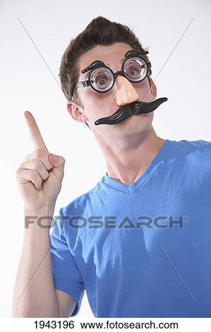 A Teenage Boy Wearing A Groucho Marx Mask And Holding A Finger Up; Troutdale Oregon United States Of America View Large Photo Image Stock Photograph - A Teenage Boy Wearing A Groucho Marx Mask And Holding A Finger Up; Troutdale Oregon United States Of America. Fotosearch