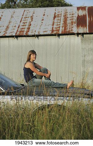 A Teenage Girl Sitting On The Hood Of A Car; Troutdale Oregon United States Of America View Large Photo Image Stock Image - A Teenage Girl Sitting On The Hood Of A Car; Troutdale Oregon United States Of America. Fotosearch