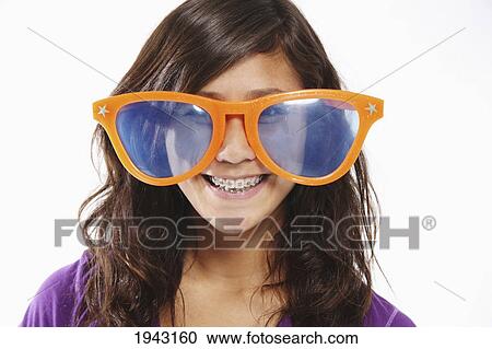 A Teenage Girl Wearing Big Orange Glasses; Troutdale Oregon United States Of America View Large Photo Image Stock Image - A Teenage Girl Wearing Big Orange Glasses; Troutdale Oregon United States Of America. Fotosearch