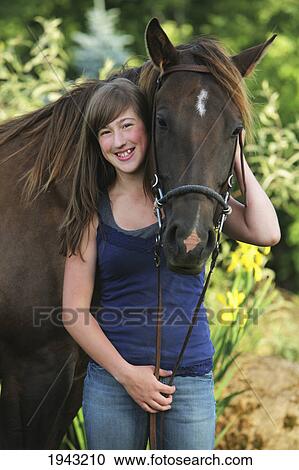 Stock Image - A Teenage Girl With A Horse; Troutdale Oregon United States Of America. Fotosearch