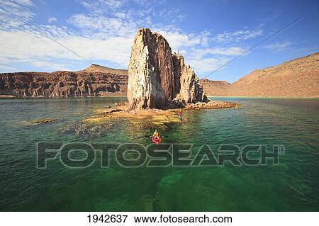 Stock Photo - A Tourist Rows In A Boat In Los Islotes National Marine Park Off Espiritu Santo Island; La Paz Baja California Sur Mexico. Fotosearch