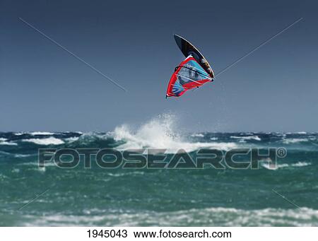 Stock Image - a windsurfer flips upside down above the water off punta paloma; tarifa cadiz andalusia spain. Fotosearch