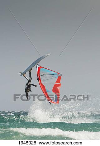 Stock Photo - a windsurfer flips upside down on the water off valdevaqueros beach; tarifa cadiz andalusia spain. Fotosearch