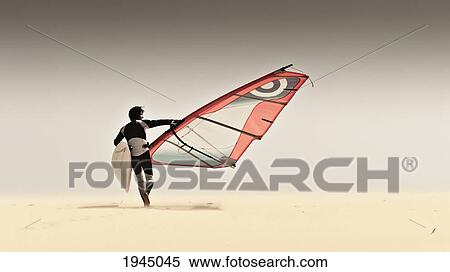 Stock Photography - a windsurfer runs on the sand of punta paloma beach with his board; tarifa cadiz andalusia spain. Fotosearch