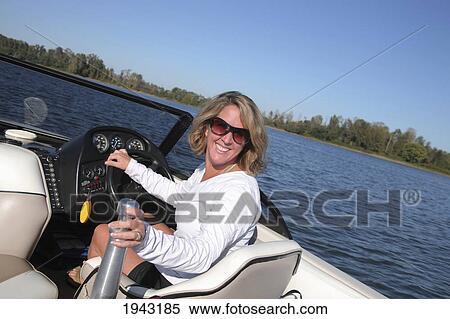 Stock Photography - A Woman Driving A Ski Boat; Portland Oregon United States Of America. Fotosearch