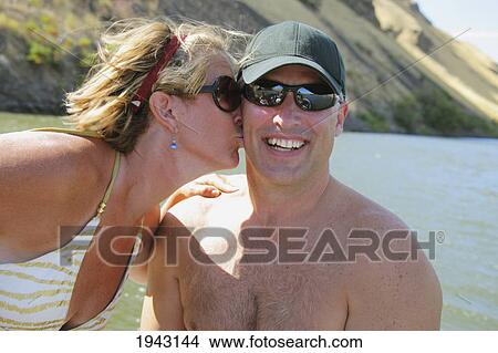 A Woman Giving A Man A Kiss On The Cheek; Dalles Oregon United States Of America View Large Photo Image Picture - A Woman Giving A Man A Kiss On The Cheek; Dalles Oregon United States Of America. Fotosearch