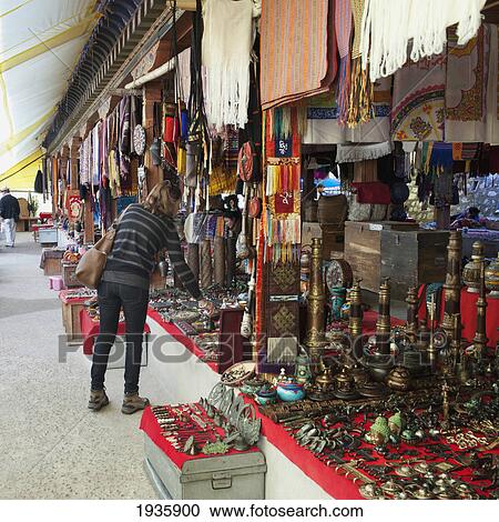Stock Image - A Woman Shops For Souvenirs; Thimphu, Thimphu District, Bhutan. Fotosearch