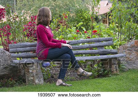 Stock Photo - A Woman Sits On A Bench At Willka T'ika Guesthouse; Peru. Fotosearch