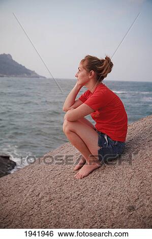 A Woman Sits On A Rock Gazing Out At The Ocean; Koh Tao Thailand View Large Photo Image Stock Photograph - A Woman Sits On A Rock Gazing Out At The Ocean; Koh Tao Thailand. Fotosearch