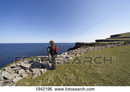 A Woman Standing Along A Ledge At The Coast; Noss Scotland View Large Photo Image Stock Photograph - A Woman Standing Along A Ledge At The Coast; Noss Scotland. Fotosearch