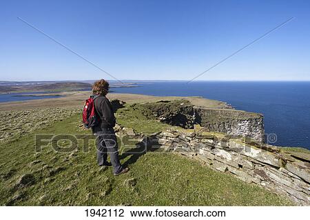 A Woman Stands Looking Out Over The Ocean; Noss Scotland View Large Photo Image Stock Image - A Woman Stands Looking Out Over The Ocean; Noss Scotland. Fotosearch