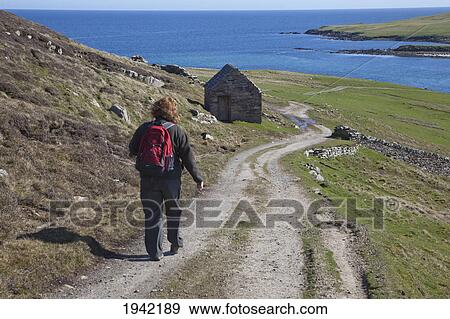 A Woman Walking On A Dirt Road Along The Coast On Her Way To Noss; Bressay Scotland View Large Photo Image Stock Photo - A Woman Walking On A Dirt Road Along The Coast On Her Way To Noss; Bressay Scotland. Fotosearch