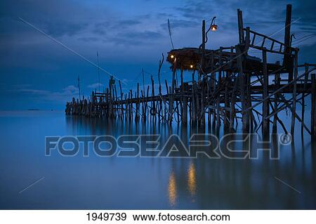 Stock Photo - a wooden pier with lights on it at night; iceland. Fotosearch