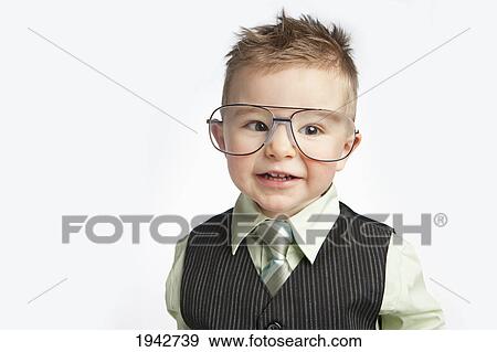 A Young Boy Dressed In A Suit And Necktie Wearing Very Large Eyeglasses; Edmonton Alberta Canada View Large Photo Image Stock Photo - A Young Boy Dressed In A Suit And Necktie Wearing Very Large Eyeglasses; Edmonton Alberta Canada. Fotosearch