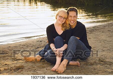 A Young Couple Sitting On The Beach; Willmar Minnesota United States Of America View Large Photo Image Stock Photograph - A Young Couple Sitting On The Beach; Willmar Minnesota United States Of America. Fotosearch