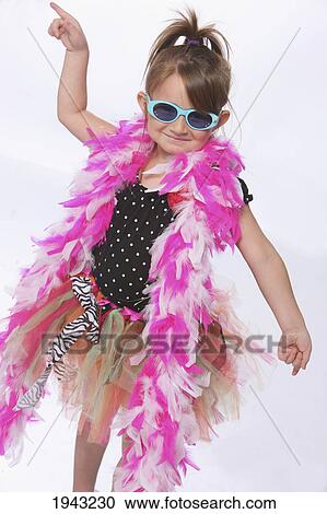 Stock Image - A Young Girl Dancing In Crazy Dress Up Clothes With Sunglasses; Troutdale Oregon United States Of America. Fotosearch