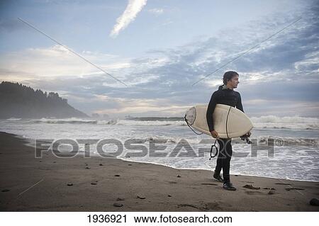 A Young Man Carries His Surfboard Down The Beach; La Push Washington United States Of America View Large Photo Image Stock Image - A Young Man Carries His Surfboard Down The Beach; La Push Washington United States Of America. Fotosearch