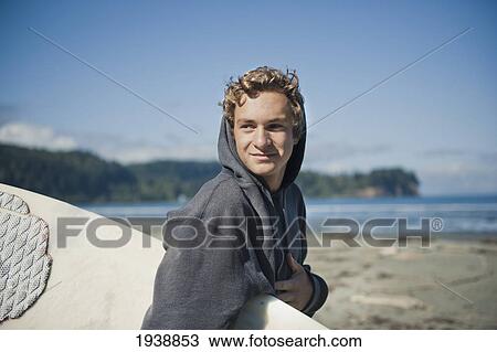A Young Man Carries His Surfboard On The Beach At Twin Rivers; Washington United States Of America View Large Photo Image Stock Image - A Young Man Carries His Surfboard On The Beach At Twin Rivers; Washington United States Of America. Fotosearch