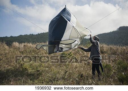 A Young Man Shakes Out His Tent On Hobuck Beach; Washington United States Of America View Large Photo Image Stock Image - A Young Man Shakes Out His Tent On Hobuck Beach; Washington United States Of America. Fotosearch
