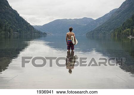 A Young Man Wearing A Swimsuit Stands In Cameron Lake; British Columbia Canada View Large Photo Image Stock Image - A Young Man Wearing A Swimsuit Stands In Cameron Lake; British Columbia Canada. Fotosearch