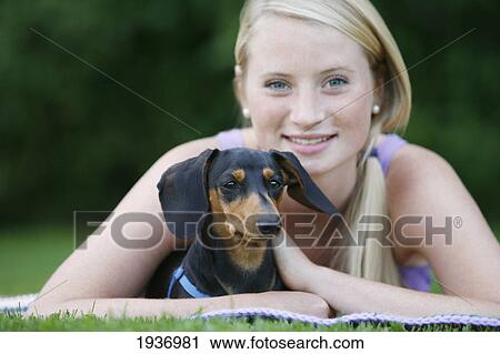 A Young Woman Holds Her Mini Dachshund Dog; Victoria British Columbia Canada View Large Photo Image Stock Image - A Young Woman Holds Her Mini Dachshund Dog; Victoria British Columbia Canada. Fotosearch
