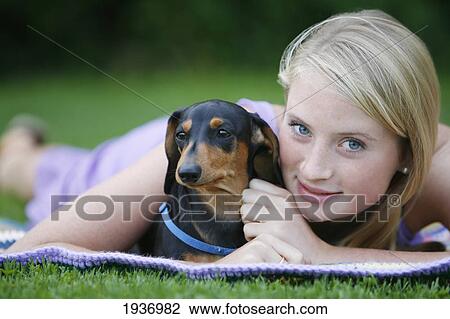 A Young Woman Holds Her Mini Dachshund Dog; Victoria British Columbia Canada View Large Photo Image Stock Image - A Young Woman Holds Her Mini Dachshund Dog; Victoria British Columbia Canada. Fotosearch