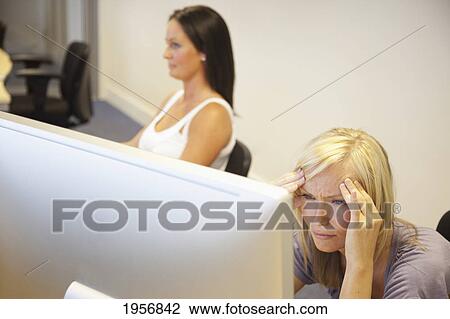 a young woman is confused as she looks at her computer screen; south shields tyne and wear england View Large Photo Image Stock Image - a young woman is confused as she looks at her computer screen; south shields tyne and wear england. Fotosearch